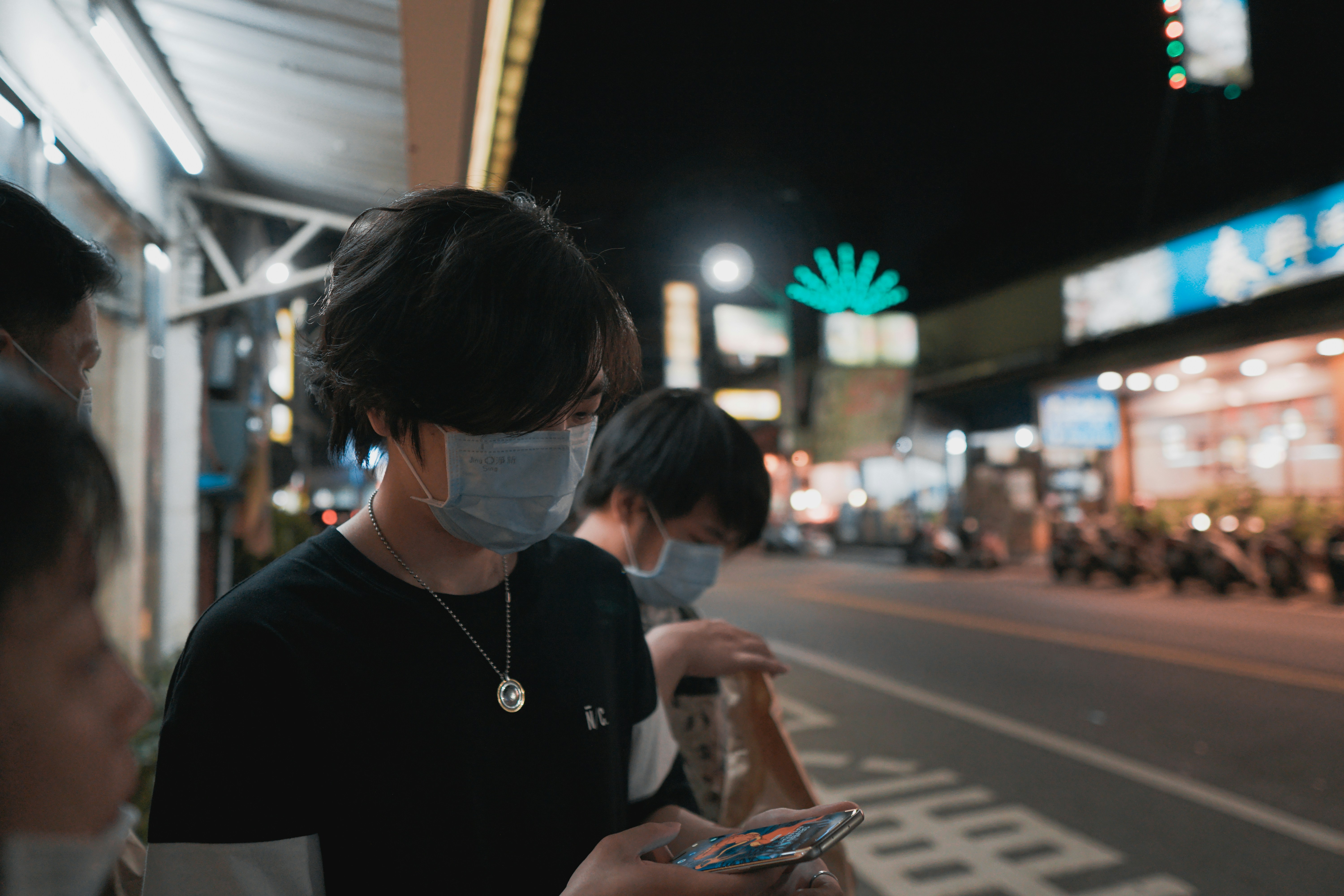 woman in black crew neck shirt wearing white headphones holding smartphone, 