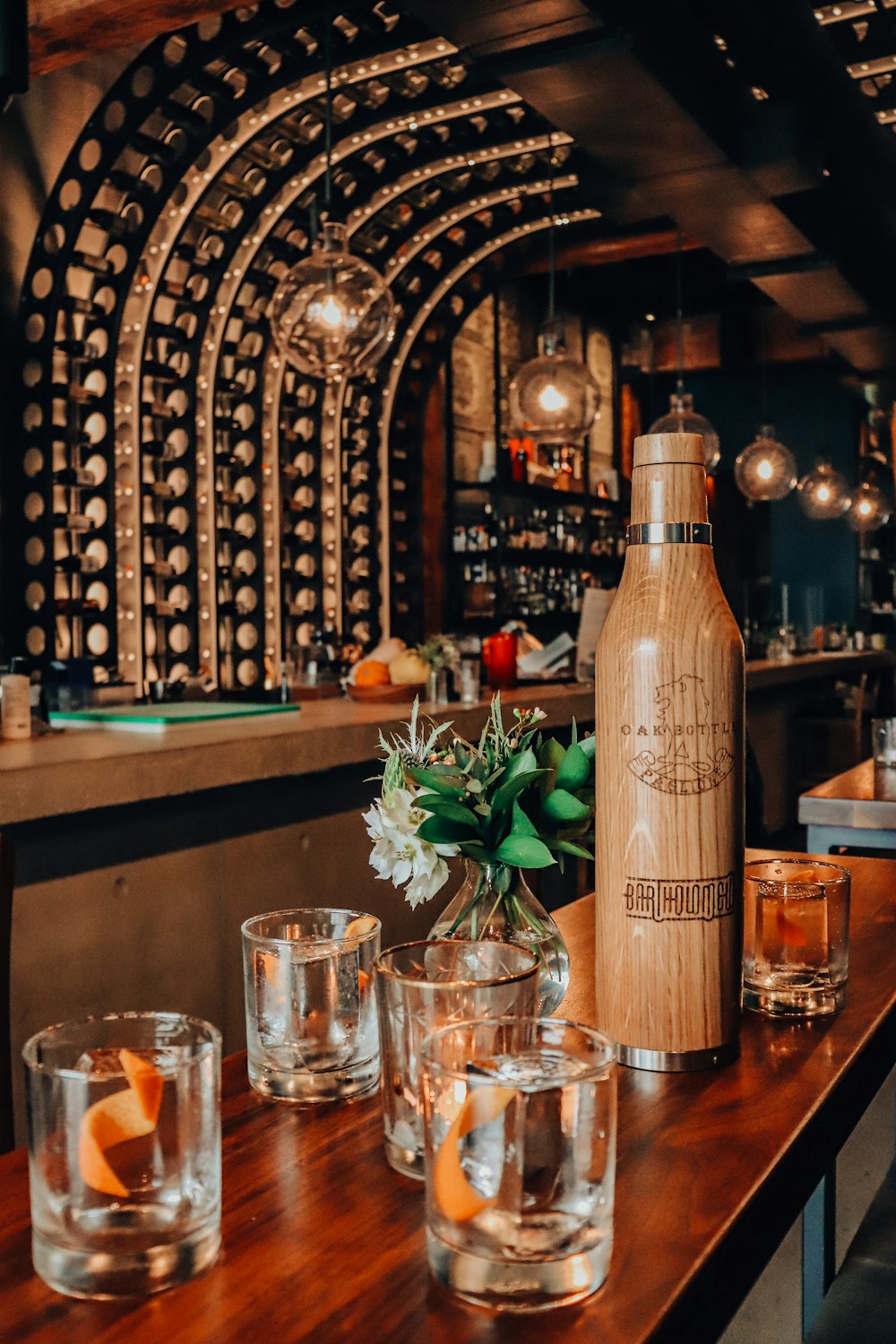 brown and black bottle beside drinking glass