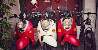 A mix of bicycles and scooters parked outside a cozy hotel opposite the Ranong bus station.