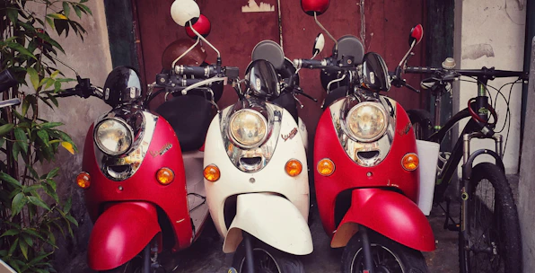 A mix of bicycles and scooters parked outside a cozy hotel opposite the Ranong bus station.