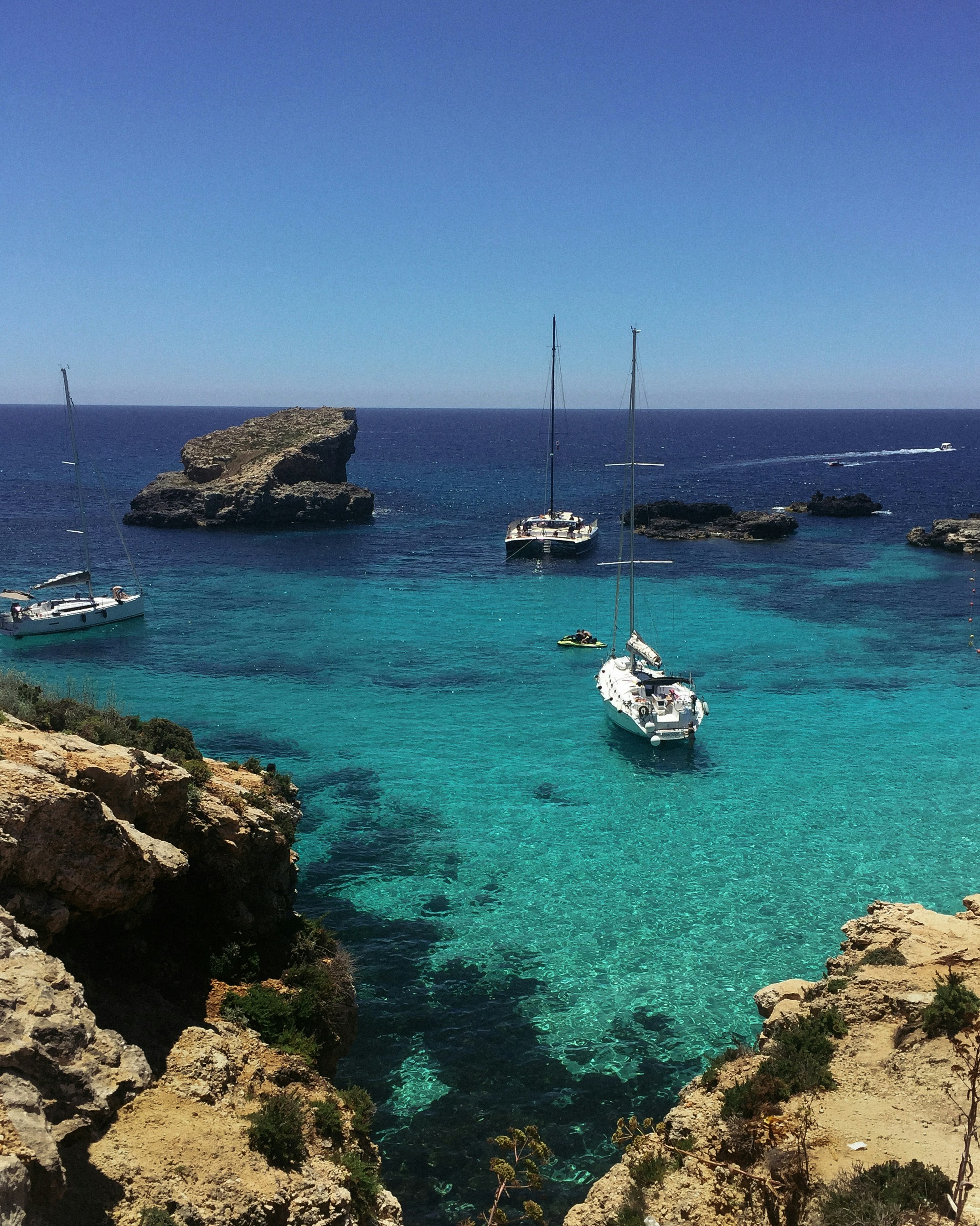 white and blue boat on sea during daytime
