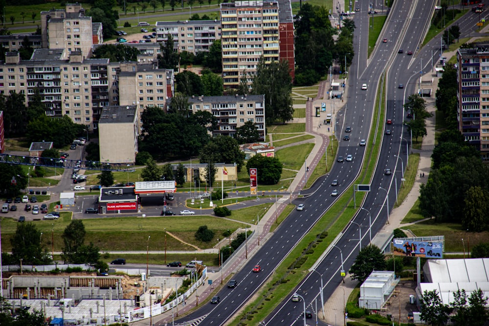 cars on road near high rise buildings during daytime