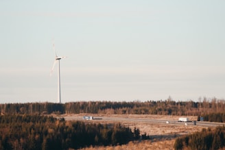 A fleet of trucks transporting wind turbine components on a highway.
