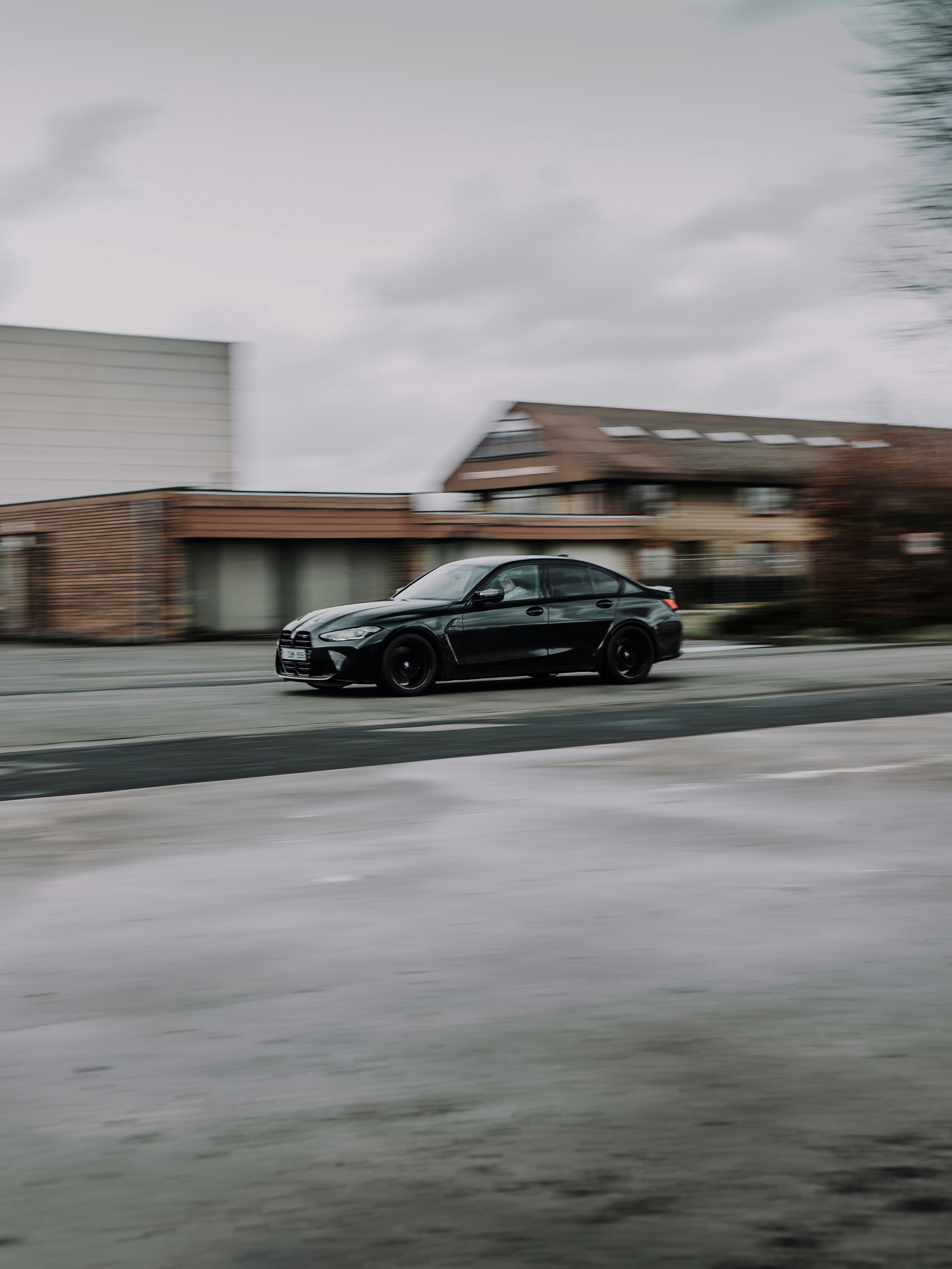 black sedan on road during daytime