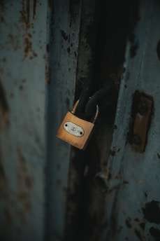 gold padlock on white wooden door