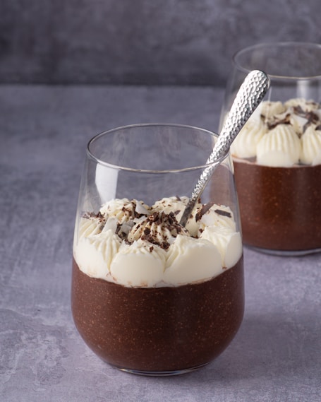 clear drinking glass with brown liquid and ice