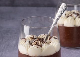 clear drinking glass with brown liquid and ice