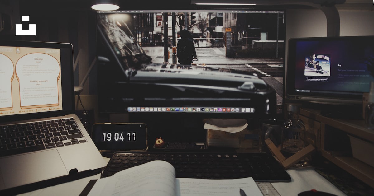 A laptop computer sitting on top of a desk next to a monitor photo ...