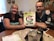 A couple reviewing insurance documents together at a kitchen table, smiling and engaged.