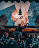 Illustration of Sunan Kalijaga with traditional wayang puppets and batik background.
