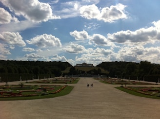 Wide shot of the estate’s garden with blooming flowers and walking paths.