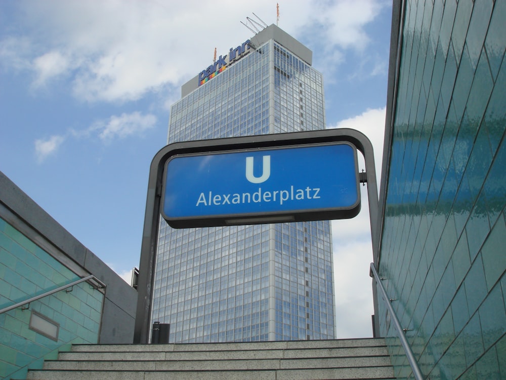 a blue sign hanging from the side of a building