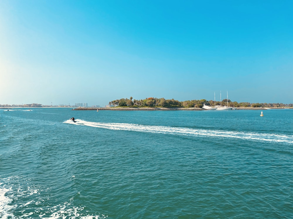 white boat on sea during daytime