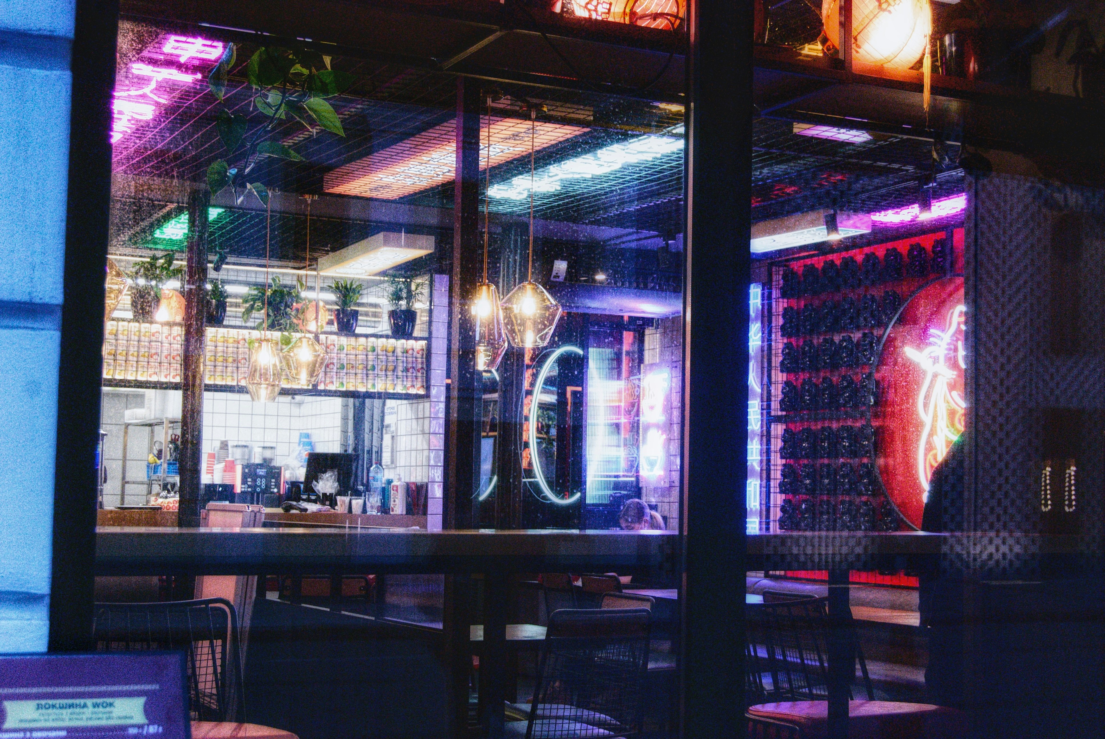 Interior restaurant retro cu lumini neon colorate, atmosferă anilor 90