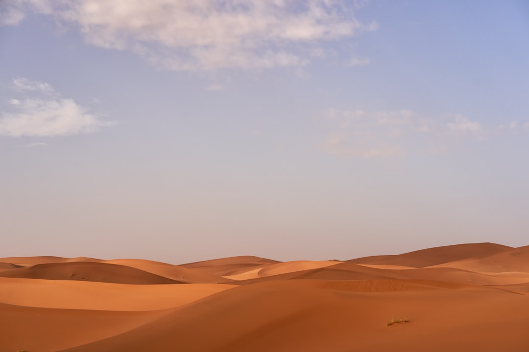 brown desert under white clouds during daytime