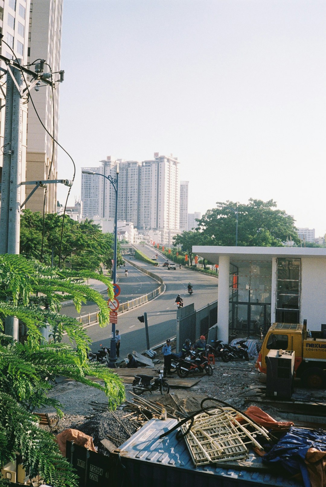 cars parked on parking lot near high rise buildings during daytime