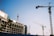 Multiple construction cranes are visible at a building site. A partially constructed building appears to the left, with cranes extended into the sky. The blue sky provides a clear backdrop, emphasizing the scale and complexity of the construction process.