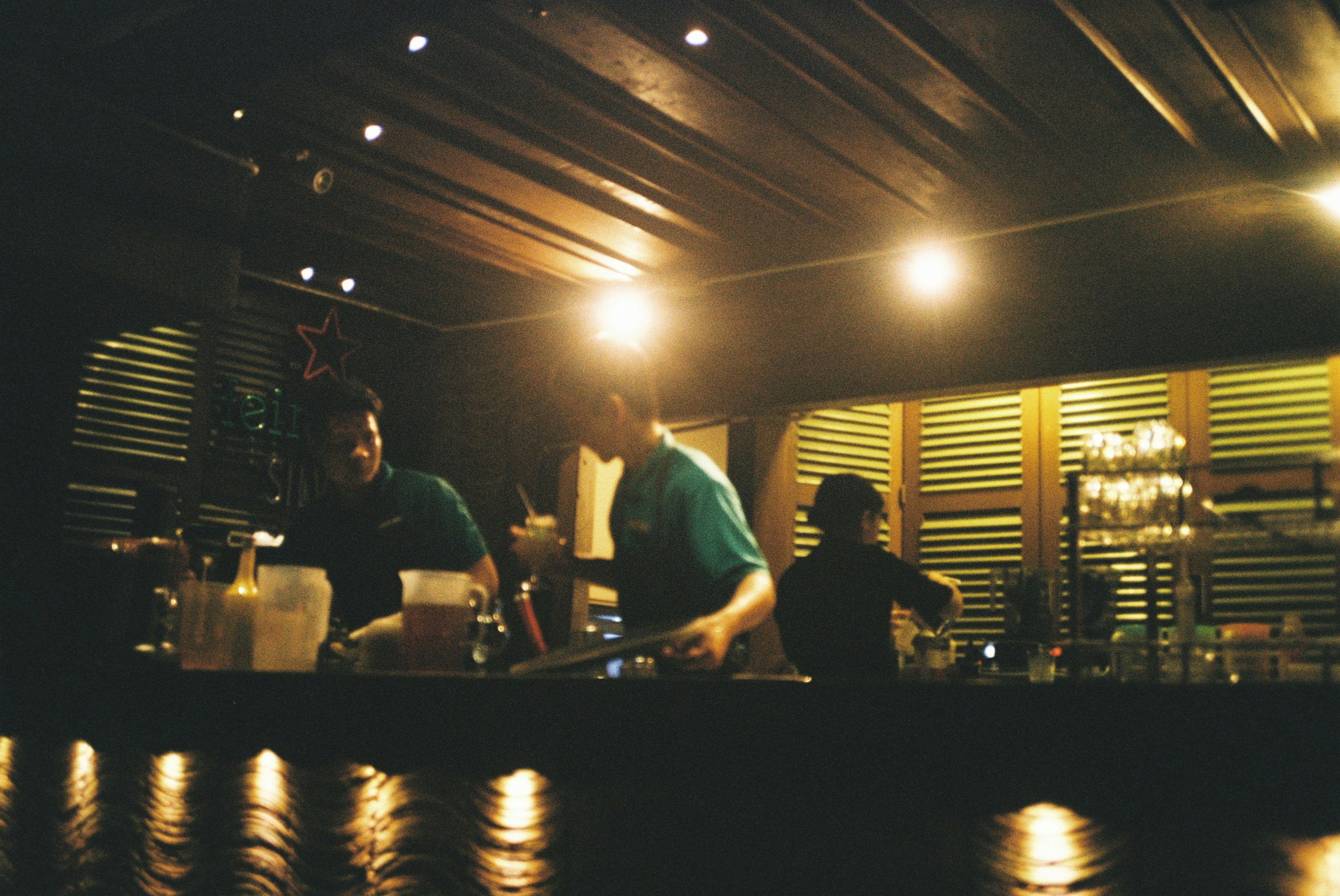 Wide-shot of production crew in a dark bar atmosphere