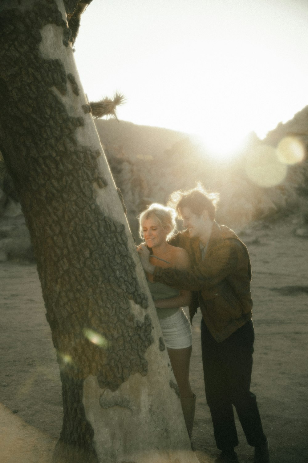 man in brown dress shirt kissing woman in brown coat