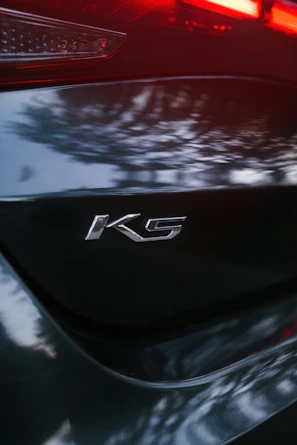 Kia badge on a modern SUV parked outdoors