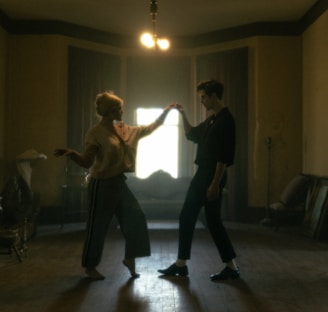 man in black t-shirt and black pants dancing with woman in black shirt