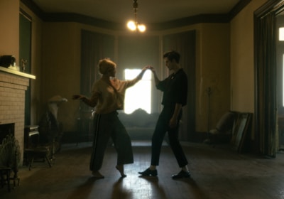 man in black t-shirt and black pants dancing with woman in black shirt