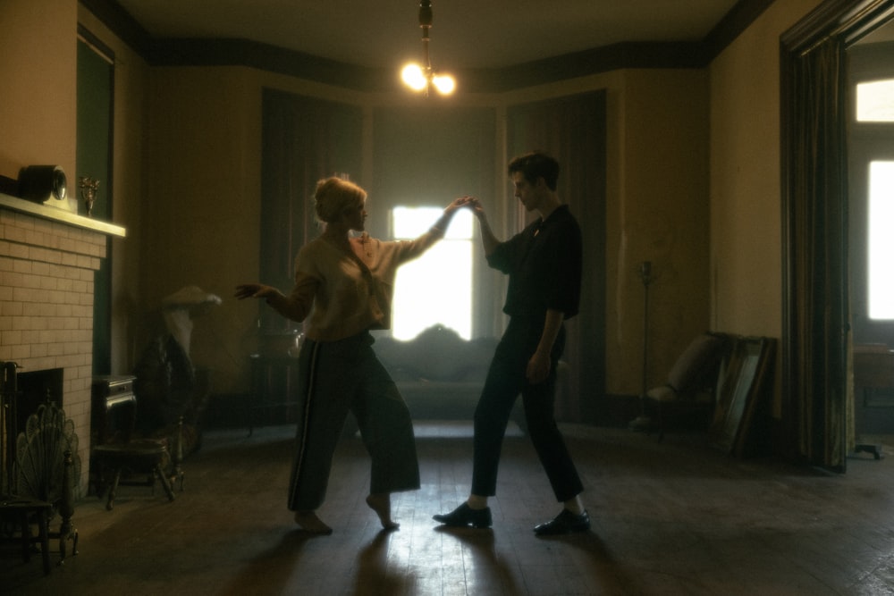 man in black t-shirt and black pants dancing with woman in black shirt