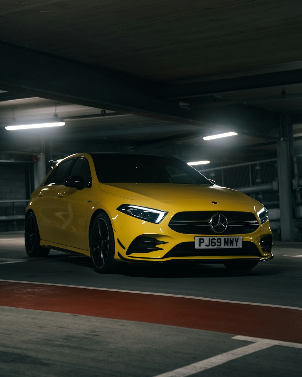 yellow mercedes benz coupe parked in garage