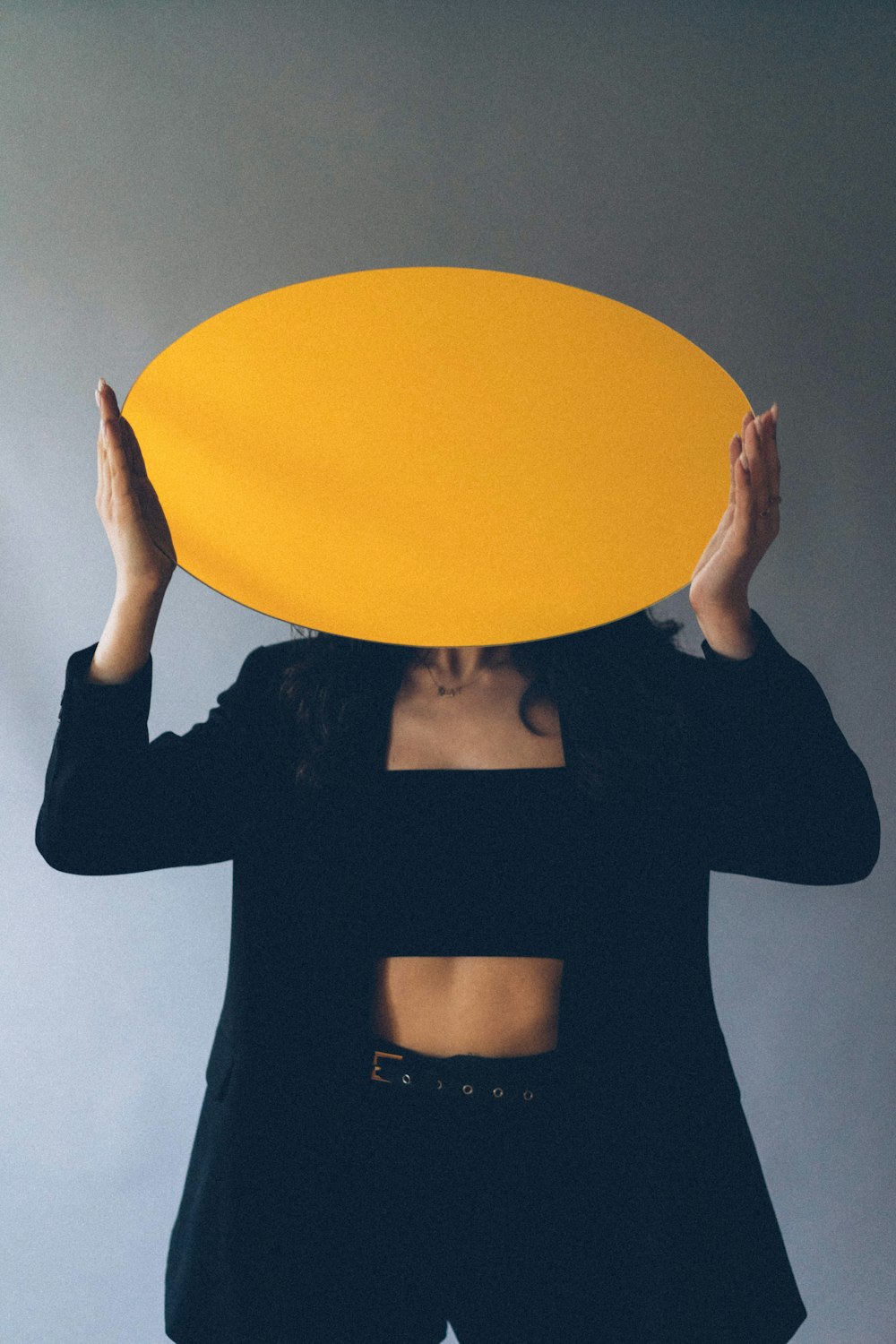 woman in black long sleeve shirt holding yellow balloon