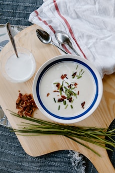 white and blue ceramic bowl with soup