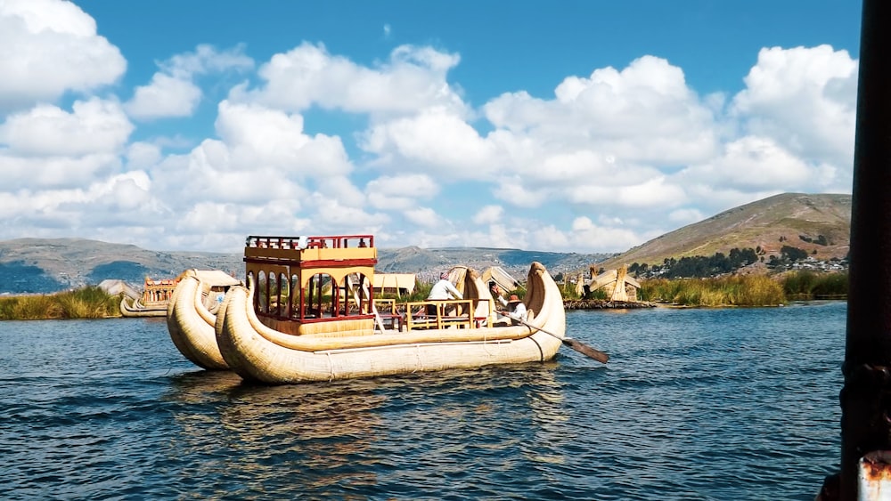 brown and white boat on water during daytime