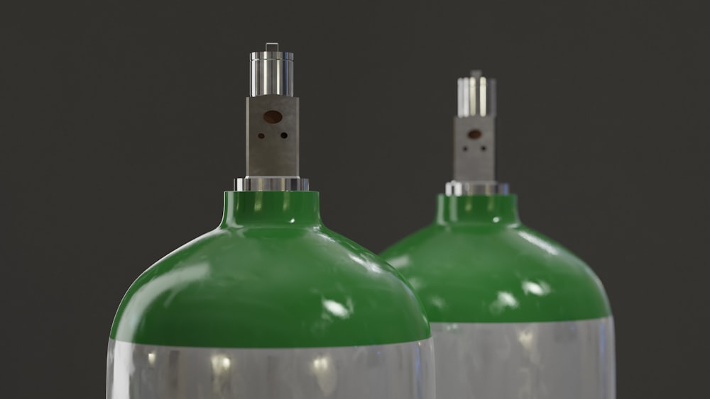 3 green glass bottles with white background