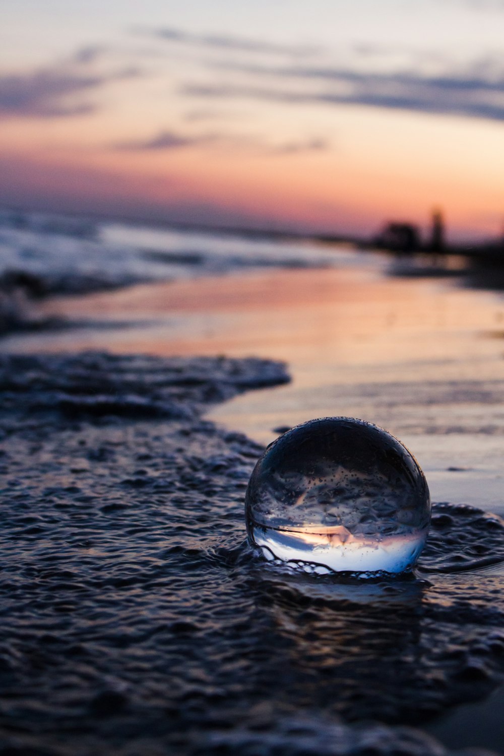 clear glass ball on beach during daytime