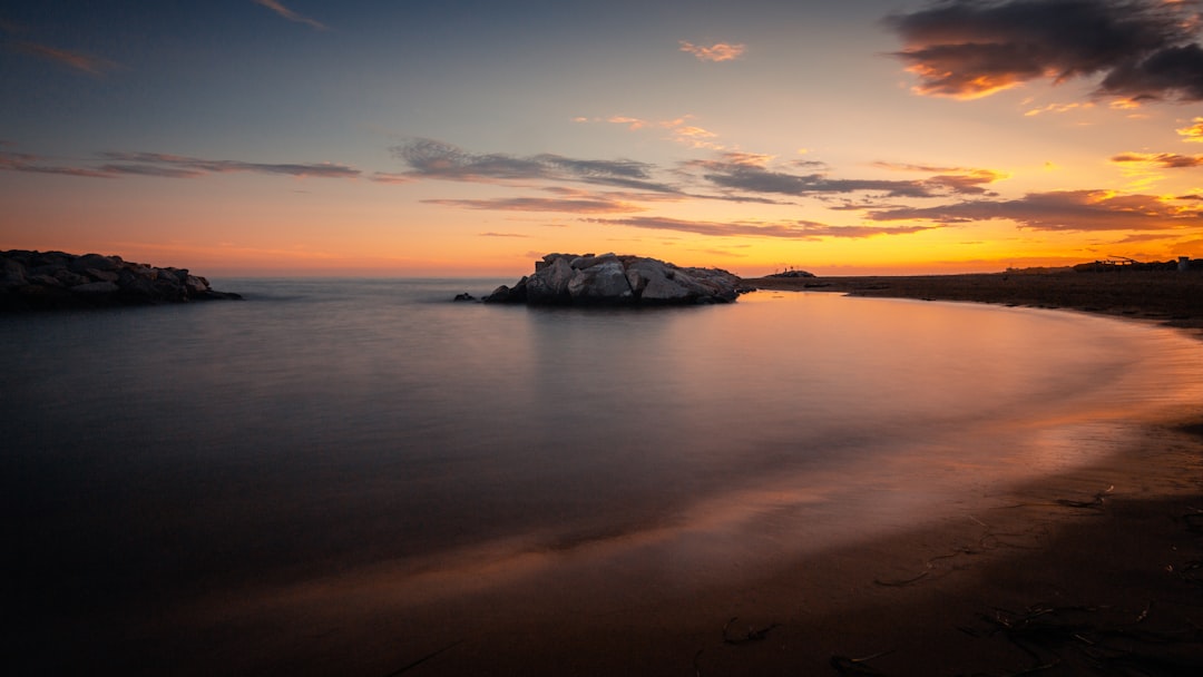 body of water during sunset