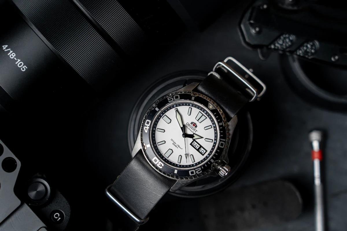 An Orient Mako II dive watch with a white dial on a black strap