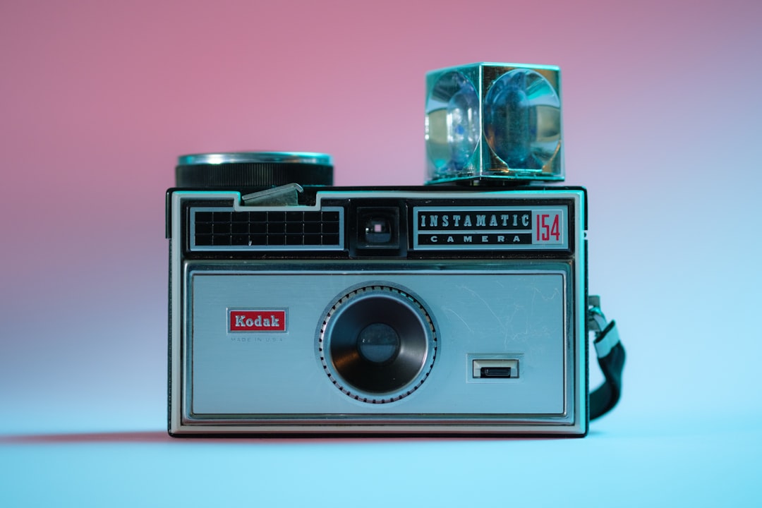 black and silver camera on white table