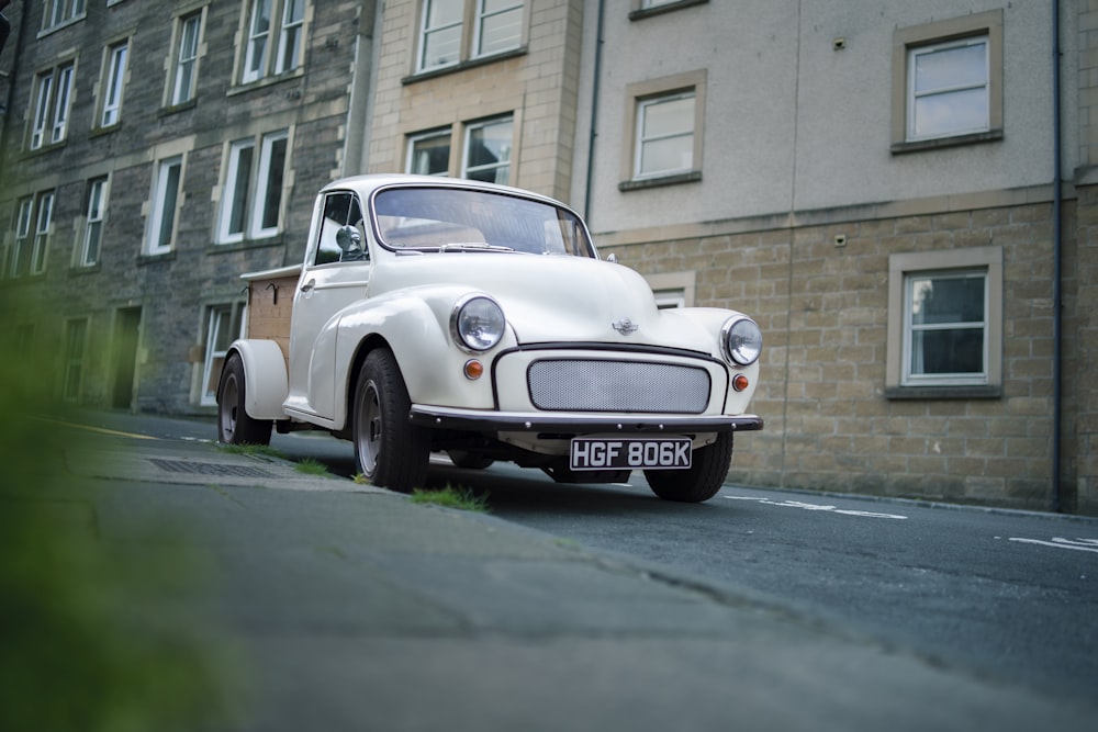 white and brown vintage car on road during daytime