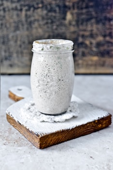 clear glass jar on white wooden table