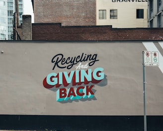 a sign on the side of a building advertising giving back