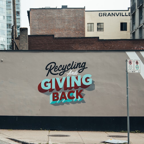 a sign on the side of a building advertising giving back