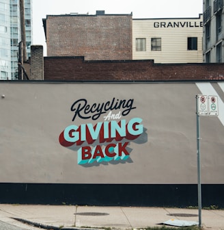 a sign on the side of a building advertising giving back