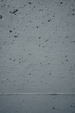 Close-up of textured concrete wall with subtle shadows.