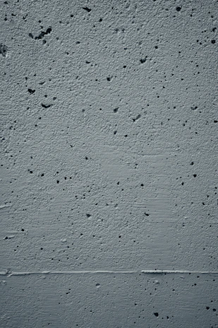 Close-up of a freshly repaired concrete wall showing smooth, even surface texture.