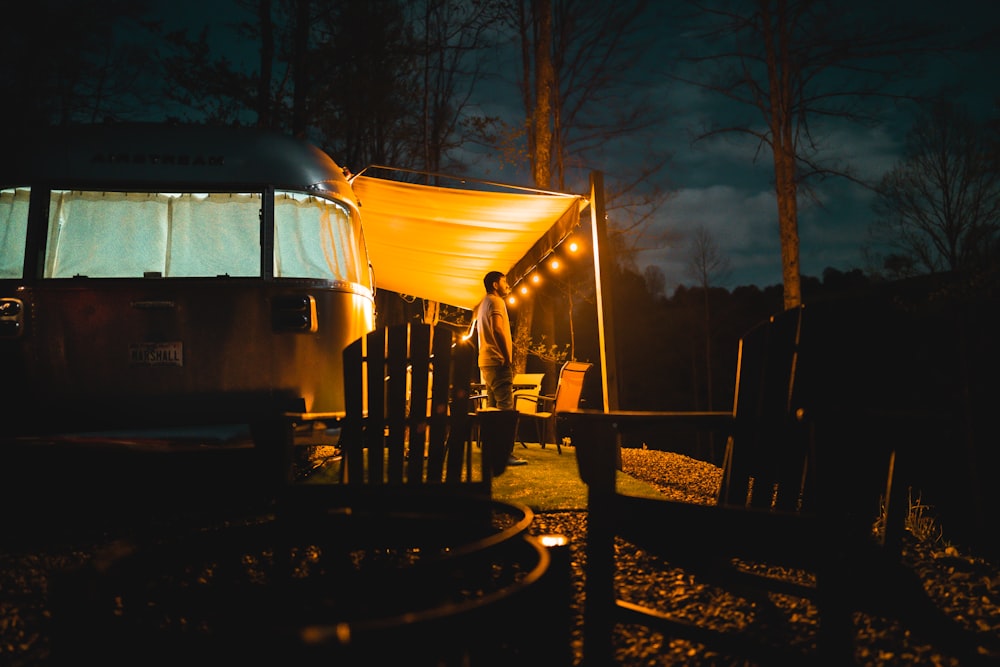 white and black tent near trees during night time