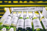 white labeled bottles on yellow and black shelf