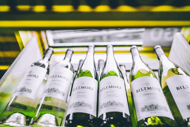 white labeled bottles on yellow and black shelf