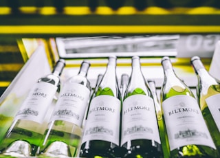 white labeled bottles on yellow and black shelf