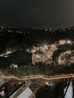 Evening view of a villa garden illuminated with soft landscape lighting.