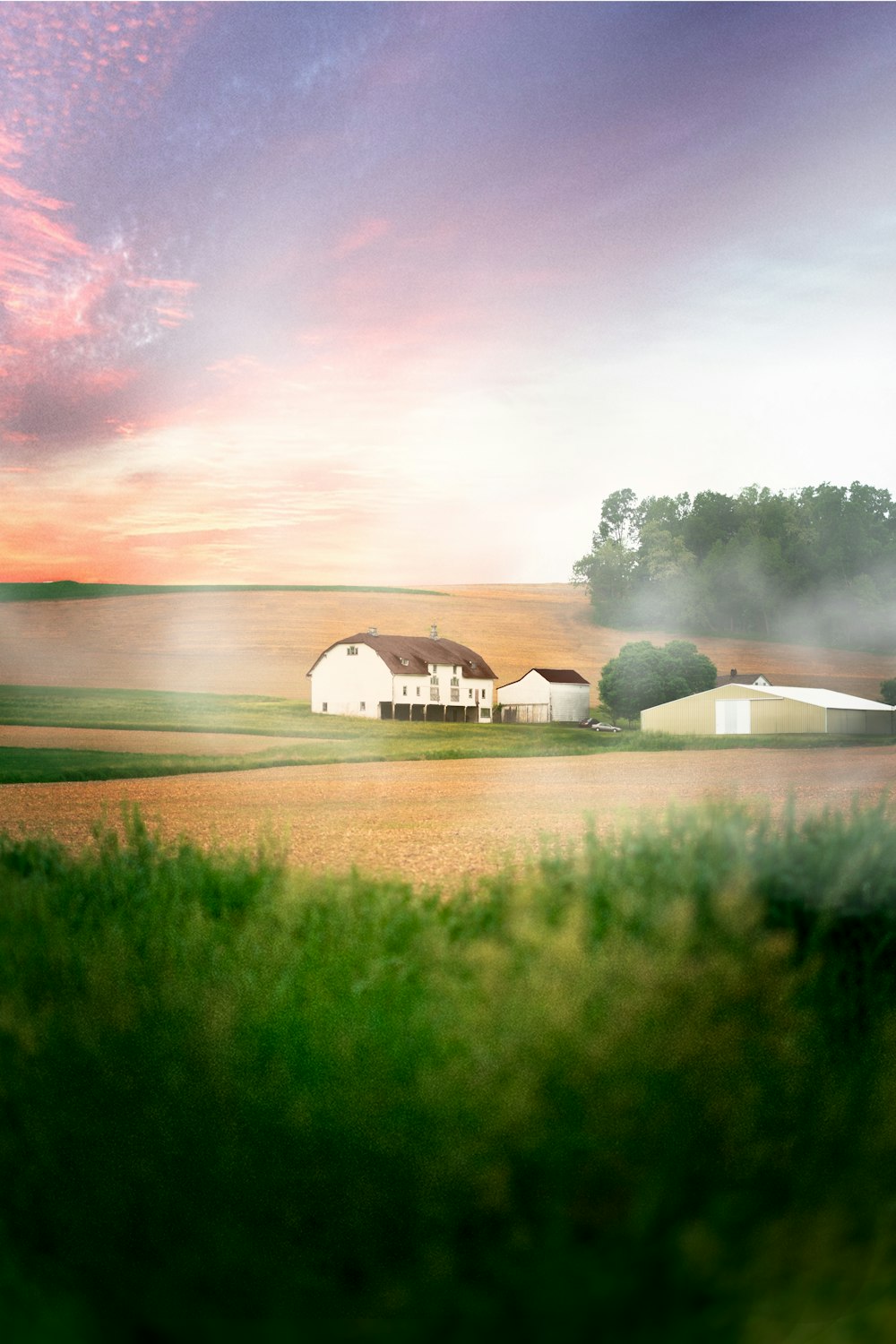 white and brown house near green grass field and lake under cloudy sky during daytime