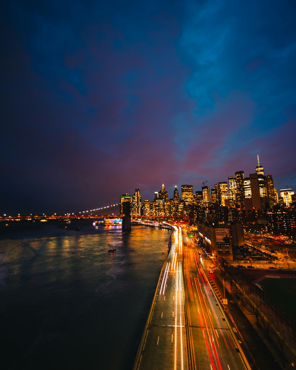 city buildings near body of water during night time